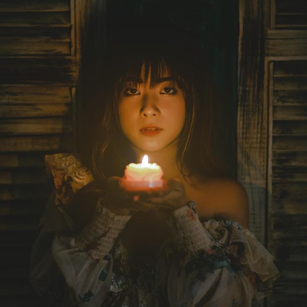 Person meditating in a calm environment with a warm background glow.